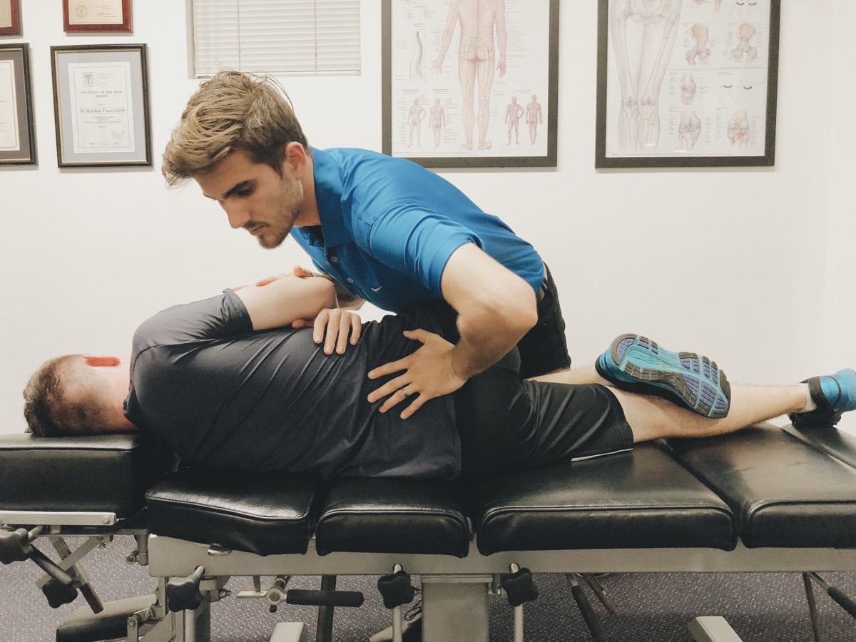 Chiropractor performing spinal adjustment at Absolute Health Mooloolaba